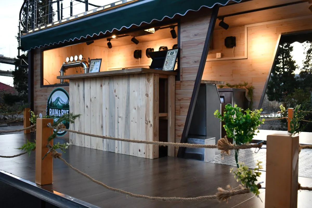 The wooden service bar with taps, lit from above